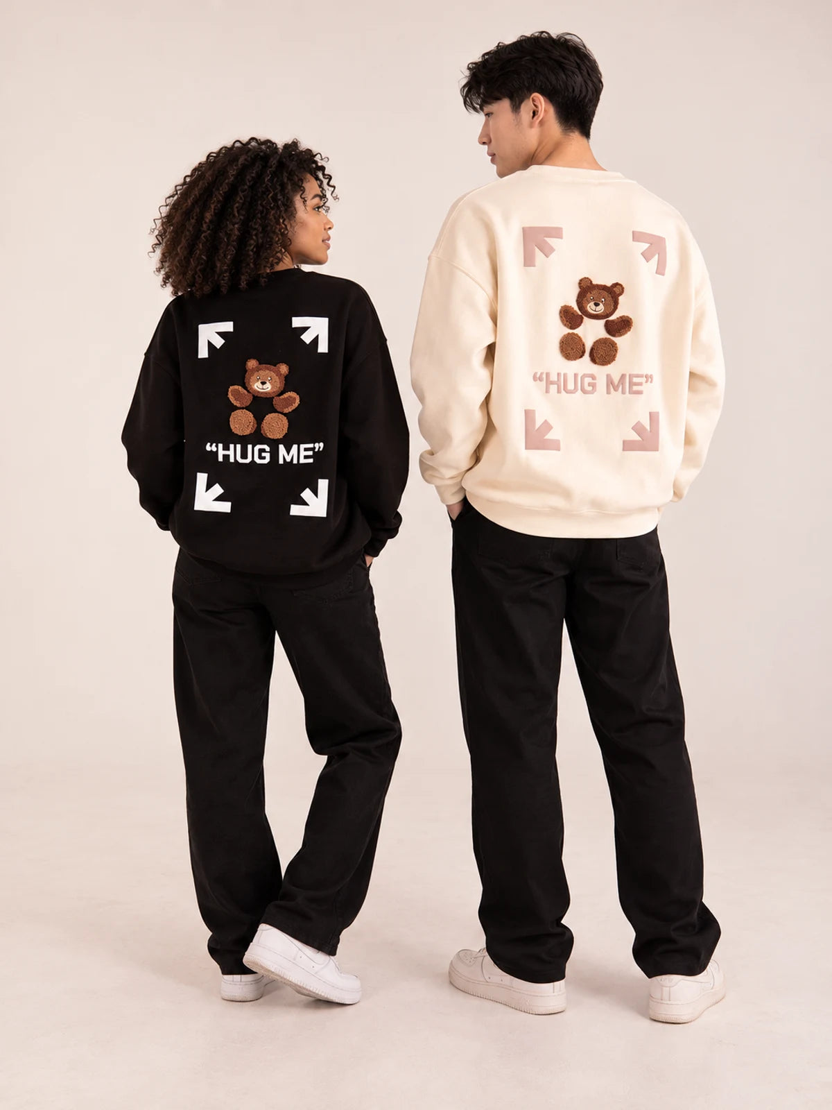 Hug Me black and beige sweaters on two models