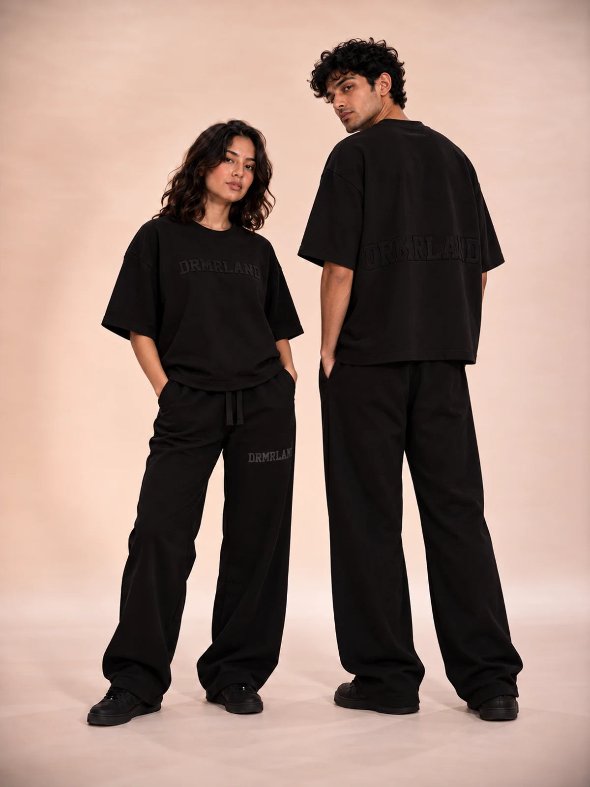 Black DREAM tees and joggers worn by two models