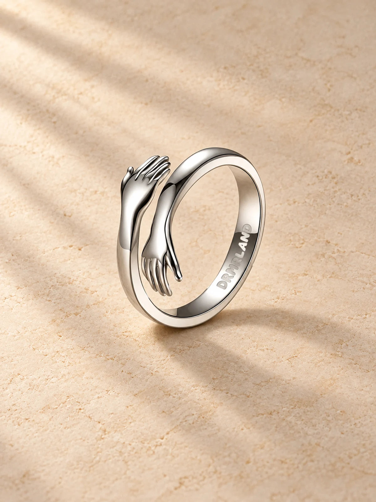 Hug Ring, silver embracing hands
